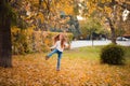 Little girl in autumn orange leaves. happy little child, baby girl laughing and playing in the autumn on the nature walk outdoors. Royalty Free Stock Photo