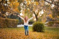 Little girl in autumn orange leaves. happy little child, baby girl laughing and playing in the autumn on the nature walk outdoors. Royalty Free Stock Photo