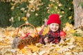 Little girl in autumn park with apple basket Royalty Free Stock Photo