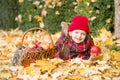 Little girl in autumn park with apple Royalty Free Stock Photo