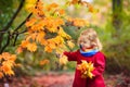 Little girl in autumn park. Child outdoor in fall Royalty Free Stock Photo