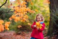 Little girl in autumn park. Child outdoor in fall Royalty Free Stock Photo