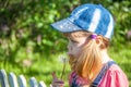 Little girl baby blows on air dandelion