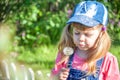 Little girl baby blows on air dandelion