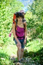 A little girl in a baby carrier walks with his mom