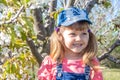 Little girl baby smiles. Spring, tree blooms in the garden Royalty Free Stock Photo