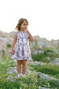 Little girl on the background of Mediterranean rocks