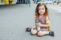 Little girl with backpack and baby bottle travel in the airport or railway station, kids travel