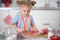Little girl baking Christmas cookies at home Royalty Free Stock Photo