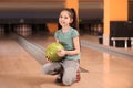 Little girl with ball in bowling Royalty Free Stock Photo