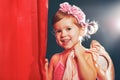 Little girl ballerina ballet dancer on stage in red side scenes Royalty Free Stock Photo