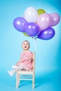 Little girl with balloons on blue background Royalty Free Stock Photo