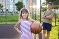 Little girl with a basketball. Children on the playground Royalty Free Stock Photo