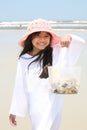 Little girl at beach with bag of shells Royalty Free Stock Photo