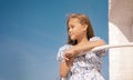 little girl on the beach with developing long blond hair in the wind and looking on the sea Royalty Free Stock Photo