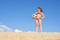 Little girl on the beach plays with a soccer ball. Sports, recreation, vacations. Family outdoor sports games Royalty Free Stock Photo