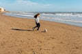 Little girl on the beach plays with a soccer ball. Sports, recreation, vacations. Family outdoor sports games Royalty Free Stock Photo