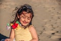 Little girl at beach, summer dressed smiling child girl playing with sand Royalty Free Stock Photo