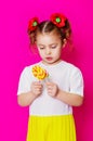 Little girl in a beautiful dress with a big candy lollipop Royalty Free Stock Photo