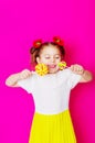 Little girl in a beautiful dress with a big candy lollipop Royalty Free Stock Photo