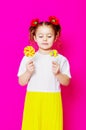 Little girl in a beautiful dress with a big candy lollipop Royalty Free Stock Photo