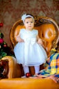 Little girl in a beautiful dress near a festive Christmas tree Royalty Free Stock Photo