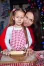 Little girl with beautiful mother baking Christmas Royalty Free Stock Photo