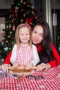 Little girl with beautiful mother baking Christmas Royalty Free Stock Photo