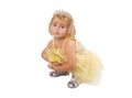 Little girl in a beautiful yellow dress and crown on white back Royalty Free Stock Photo