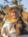 Little girl beekeeper blows smoker for bees Royalty Free Stock Photo