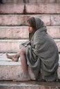 Little girl begger sitting on stairs,Vanarasi