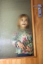 Little girl behind structured glas door Royalty Free Stock Photo