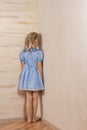 Little girl being punished standing in the corner Royalty Free Stock Photo