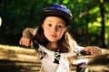 Little girl with bicycle in summer park outdoors Royalty Free Stock Photo