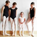 Little girl, big ballerina dreams. a group of young ballerinas teaching a little girl ballet in a dance studio. Royalty Free Stock Photo