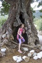 Little girl in a big olive tree