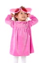 A little girl with big pink glasses