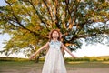 Huge Tree. a little girl by a big tree. child near with large green old oak Royalty Free Stock Photo