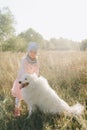 Little girl with a big white dog in nature Royalty Free Stock Photo