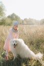 Little girl with a big white dog in nature Royalty Free Stock Photo