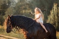 Little girl with black friesian stallion Royalty Free Stock Photo