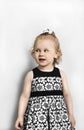 Little Girl in black and white dress standing Royalty Free Stock Photo