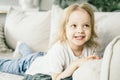 Little girl with blond hair having fun at home. Royalty Free Stock Photo