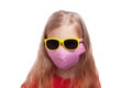 Little girl with blond hair wearing protective pink fabric mask and sunglasses against coronavirus COVID-19 pandemic Royalty Free Stock Photo