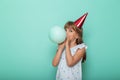 Little girl blowing a balloon and celebrating birthday Royalty Free Stock Photo