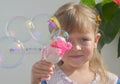 Little girl blowing bubbles