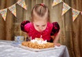 Little girl blowing candles