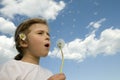 Little girl blowing dandelion Royalty Free Stock Photo