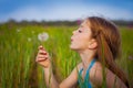 Little girl blowing dandelion Royalty Free Stock Photo