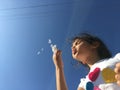 A little girl blowing dandelion seeds. Royalty Free Stock Photo